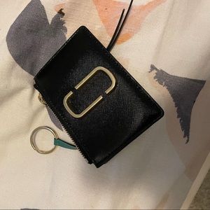 Marc Jacob’s snapshot top zip multi wallet. It’s black, white with brown